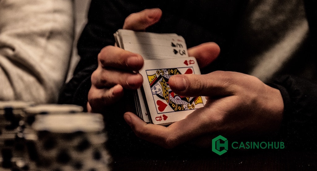 person holding playing cards for poker game